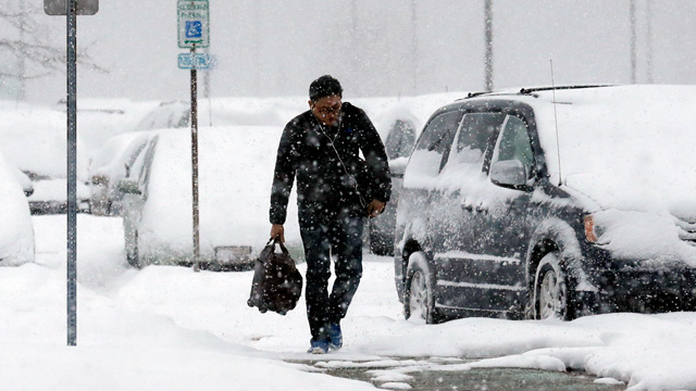 A traveler walks in snow in Chicago